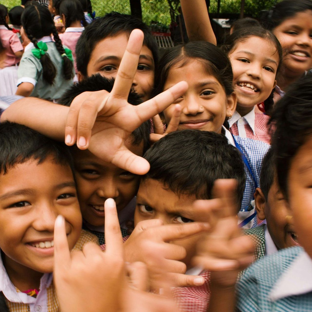 A group of children are giving the peace sign