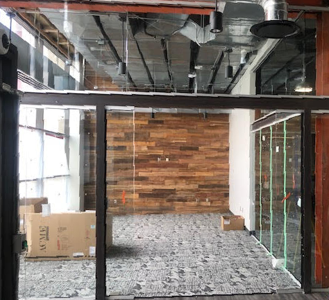 An empty room with a wooden wall and a box that says ' a ' on it