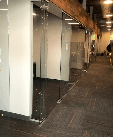 A long hallway with sliding glass doors in an office building.