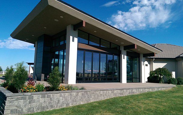 A large building with a lot of windows and a roof