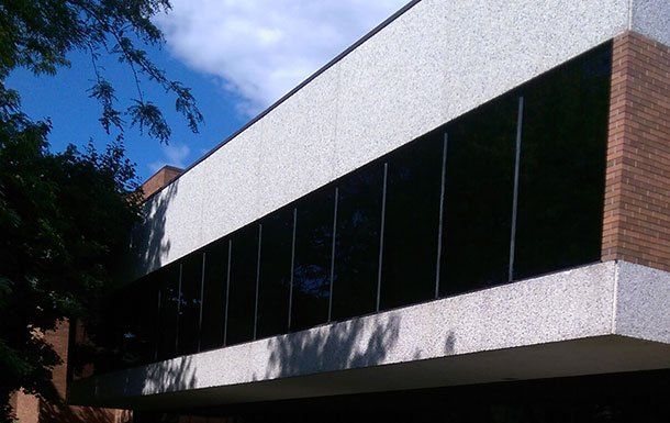 A large building with a lot of windows on a sunny day