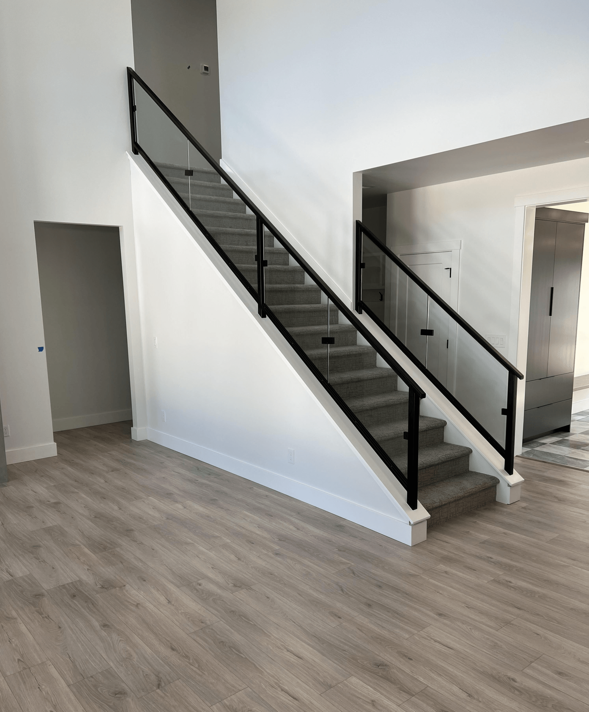 A staircase with a glass railing in a house