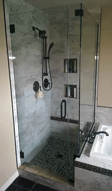 A bathroom with a walk in shower and a sink.