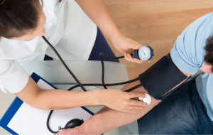 Nurse Measuring Patient's Blood Pressure — Peoria, IL — The Insurance Office