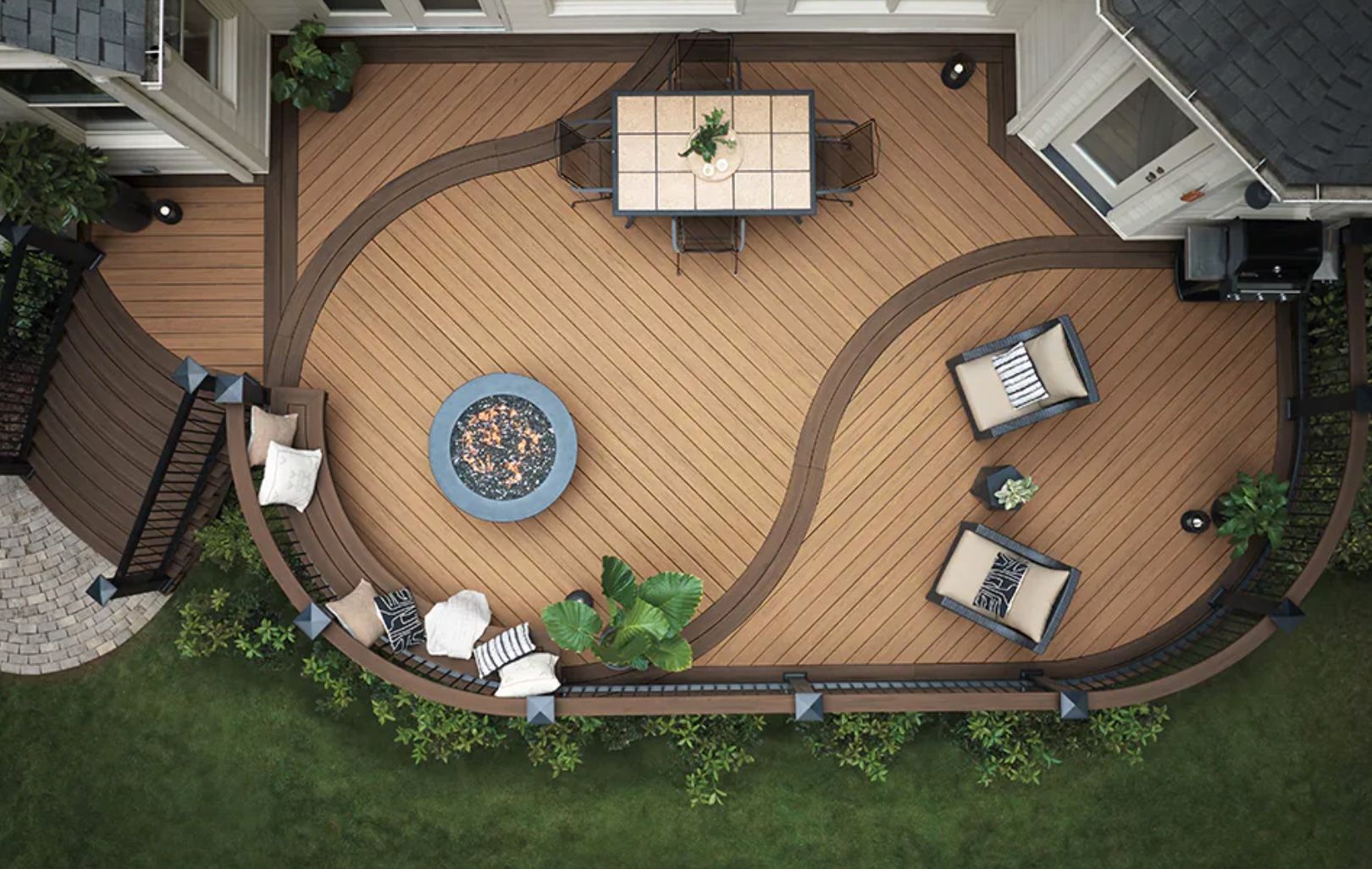 Overhead view of a unique brown and tan deck with furniture, fire pit, and garden.