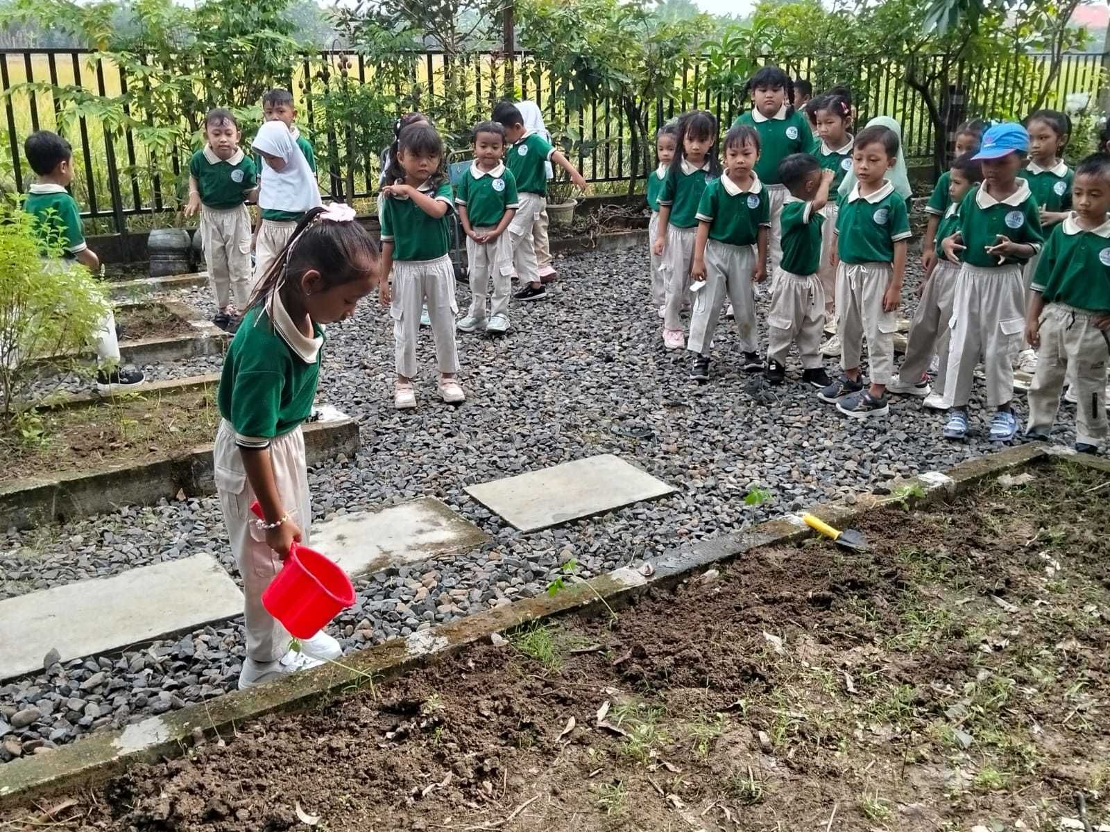 Children playing a game on a red mat with lily pad markers in an indoor event space, observed by adults.