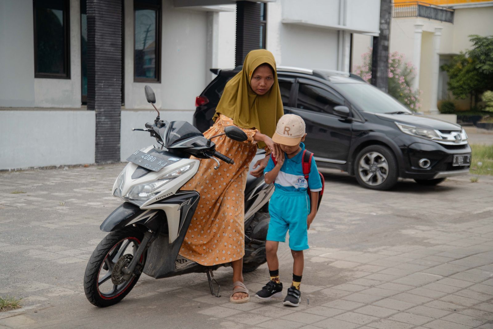 A group of women in hijabs take notes in a brightly lit room.