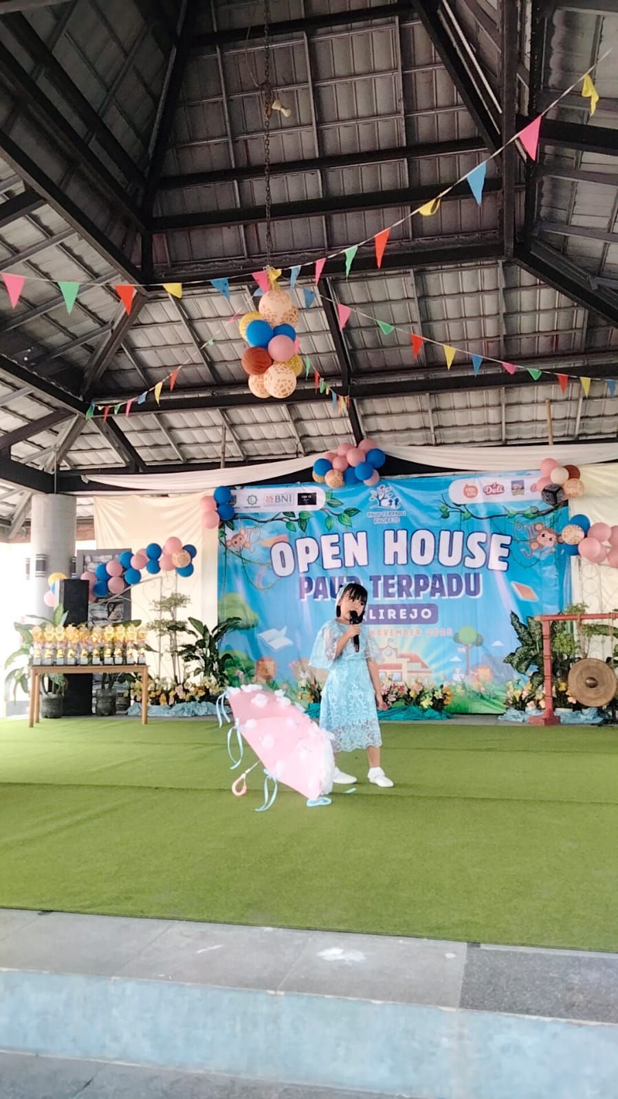Child on stage with umbrella at an