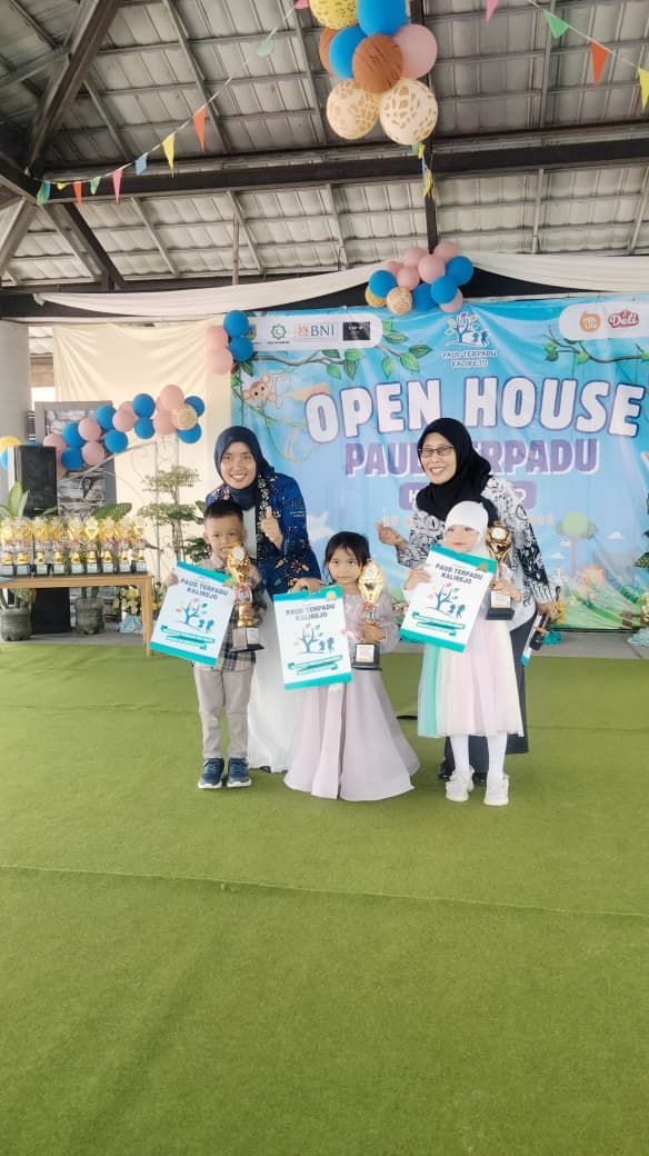 Children holding awards with adults at an