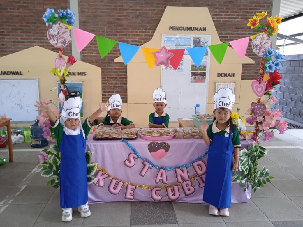 Children in chef hats and aprons at a