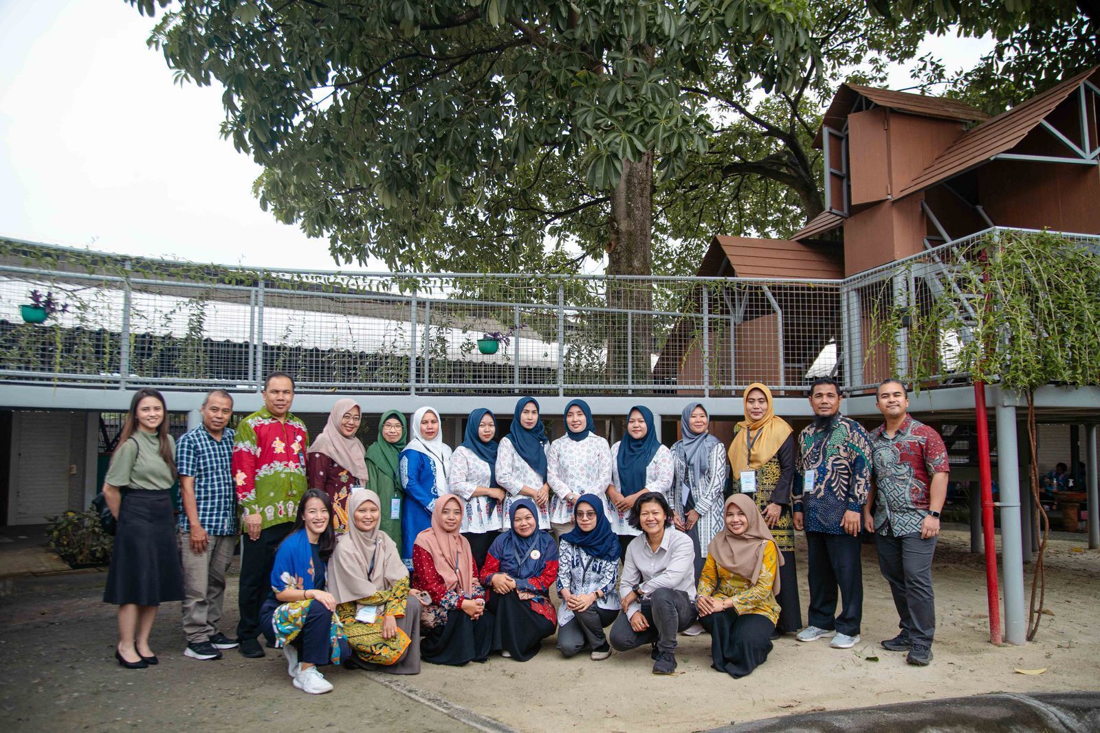 People in a meeting at a table, watching a presentation on a screen.