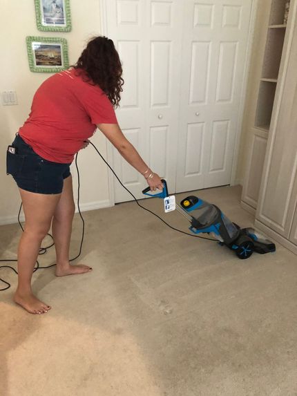 A group of people are cleaning a kitchen.