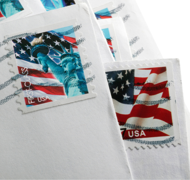 Envelopes with American flag and Statue of Liberty stamps.
