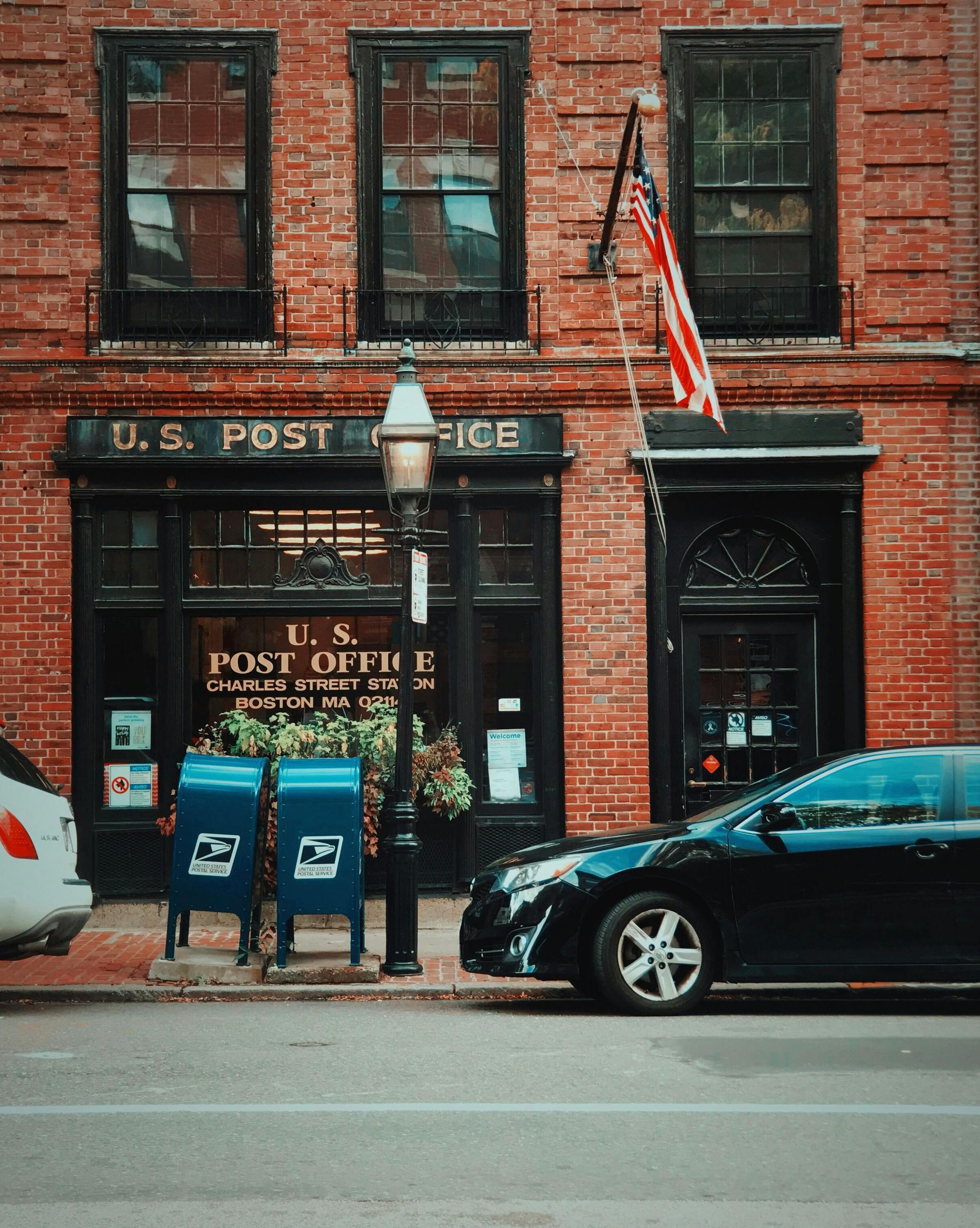 A car is parked in front of the u.s. post office
