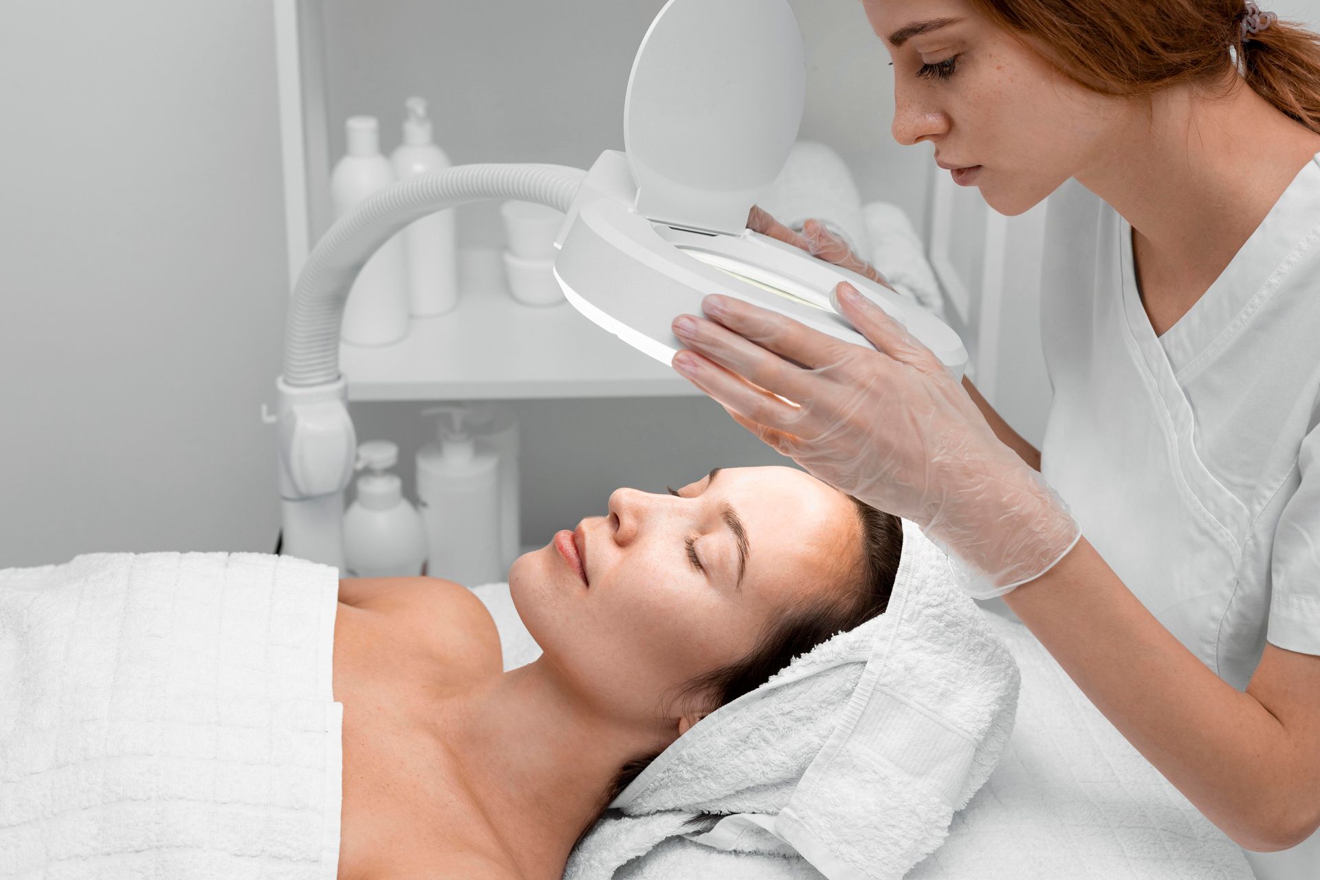 A woman is getting a facial treatment at a beauty salon.