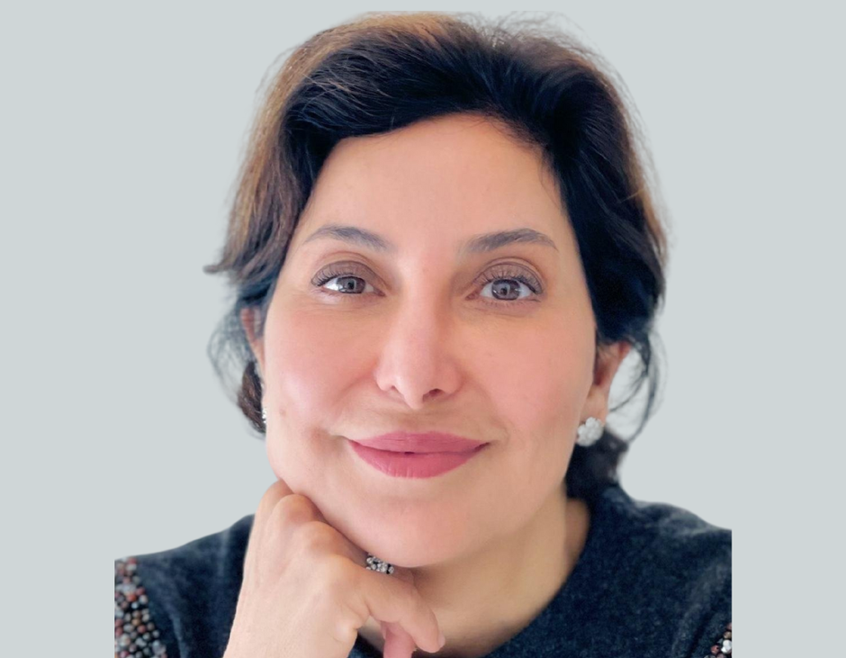 A close up of a woman 's face with her hand on her chin.