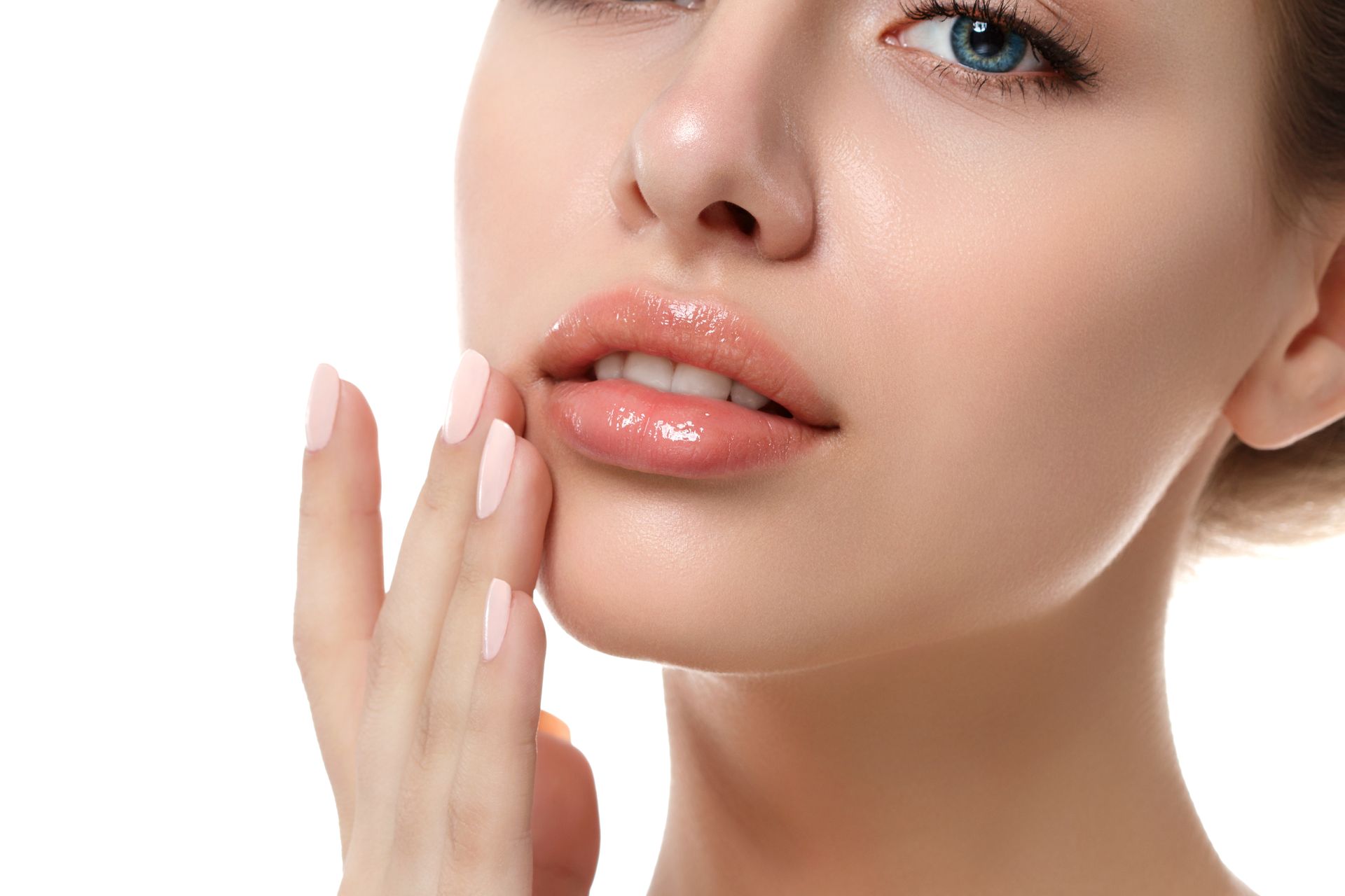 A close up of a woman 's face with her hand on her chin.