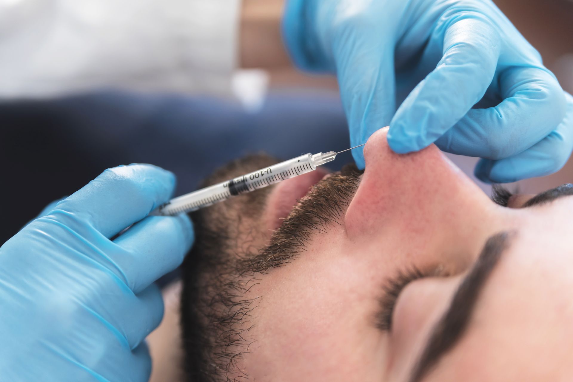 A man is getting an injection in his nose.