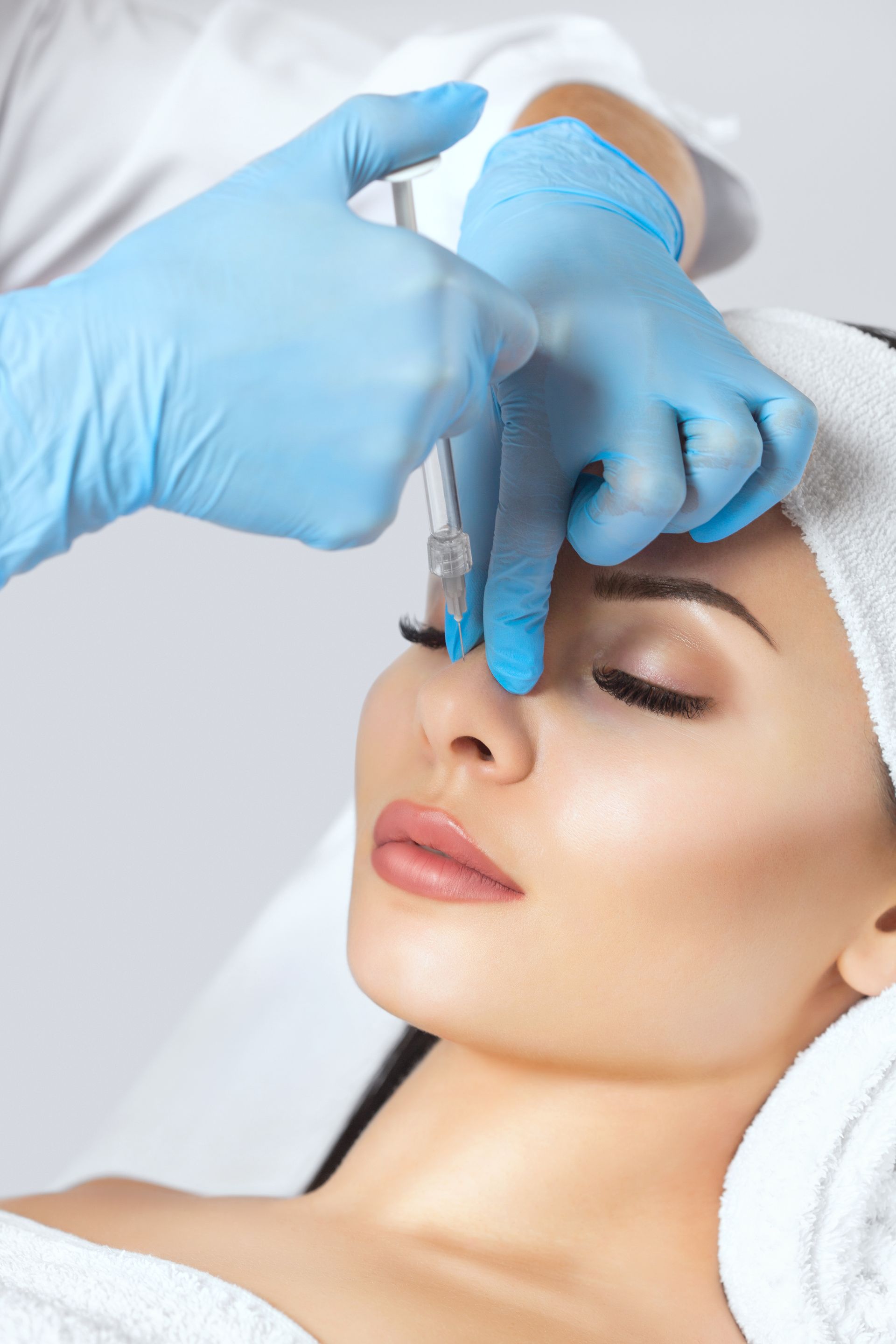 A woman is getting an injection in her nose.