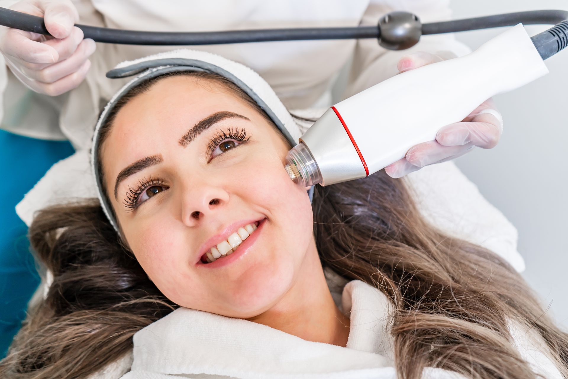 A woman is getting a facial treatment at a beauty salon.