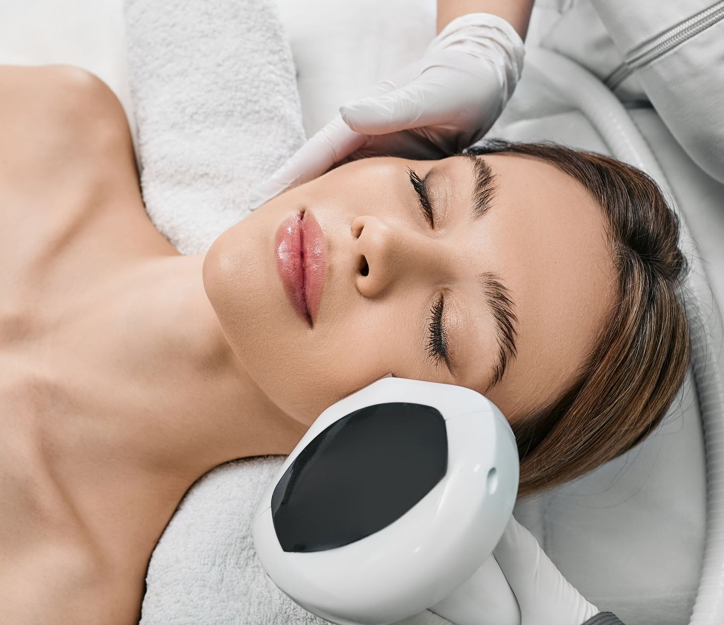 A woman is getting a facial treatment in a spa.