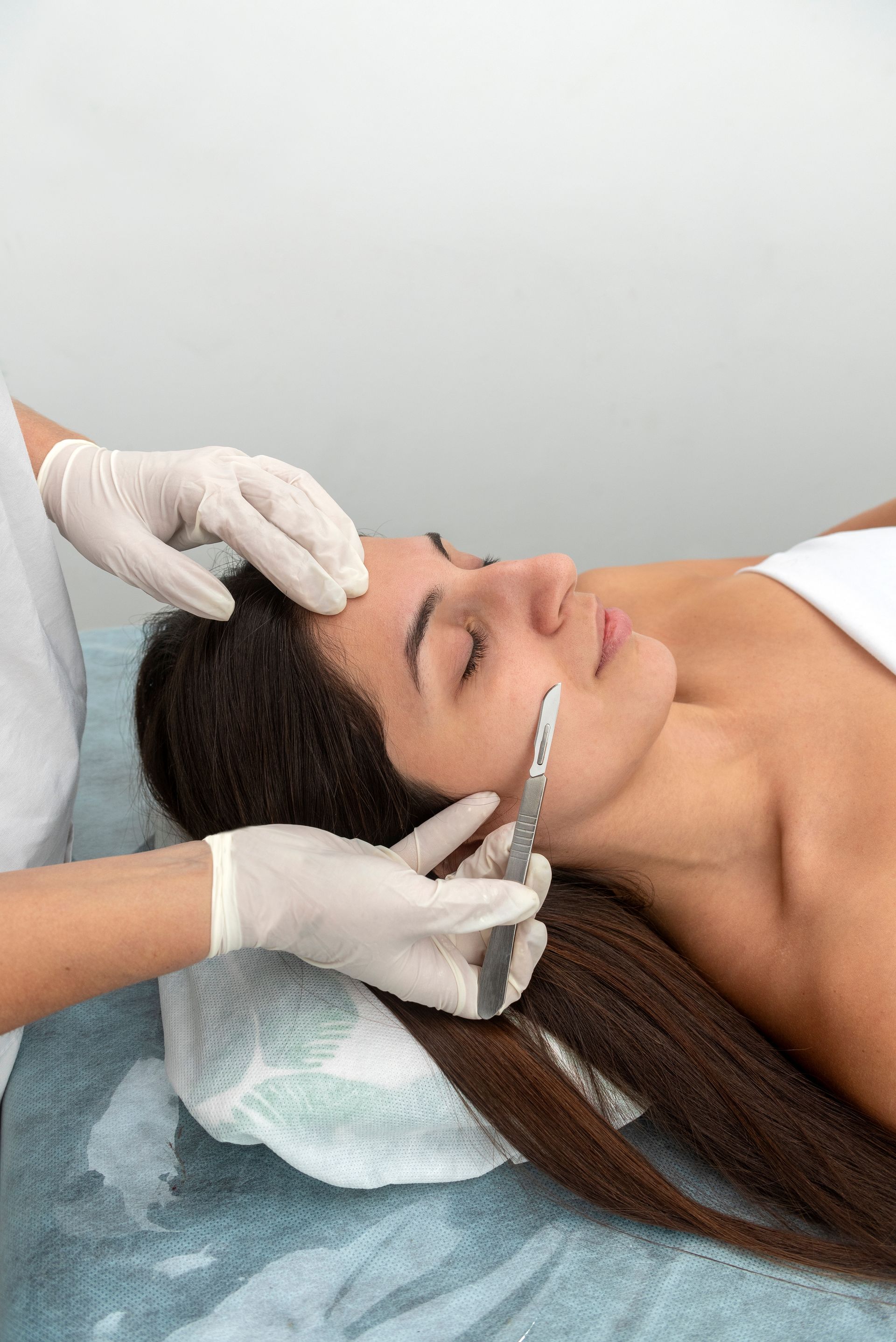 A woman is getting a facial treatment at a beauty salon.