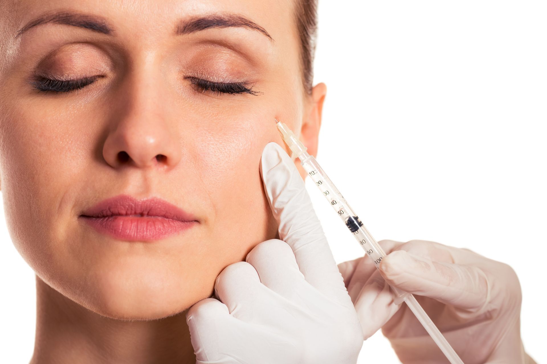 A woman is getting a botox injection in her face.