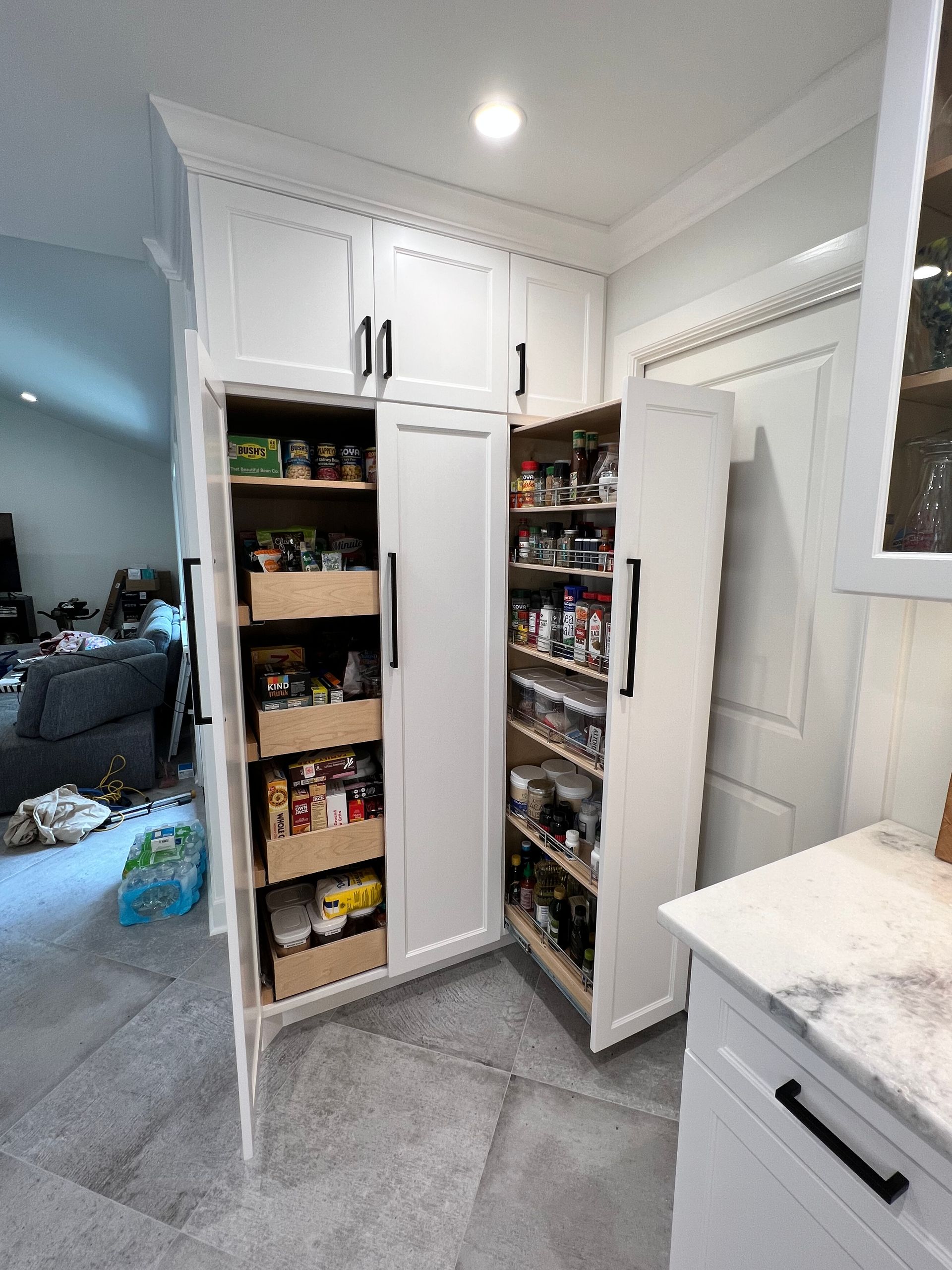 A kitchen with a pantry filled with lots of food.