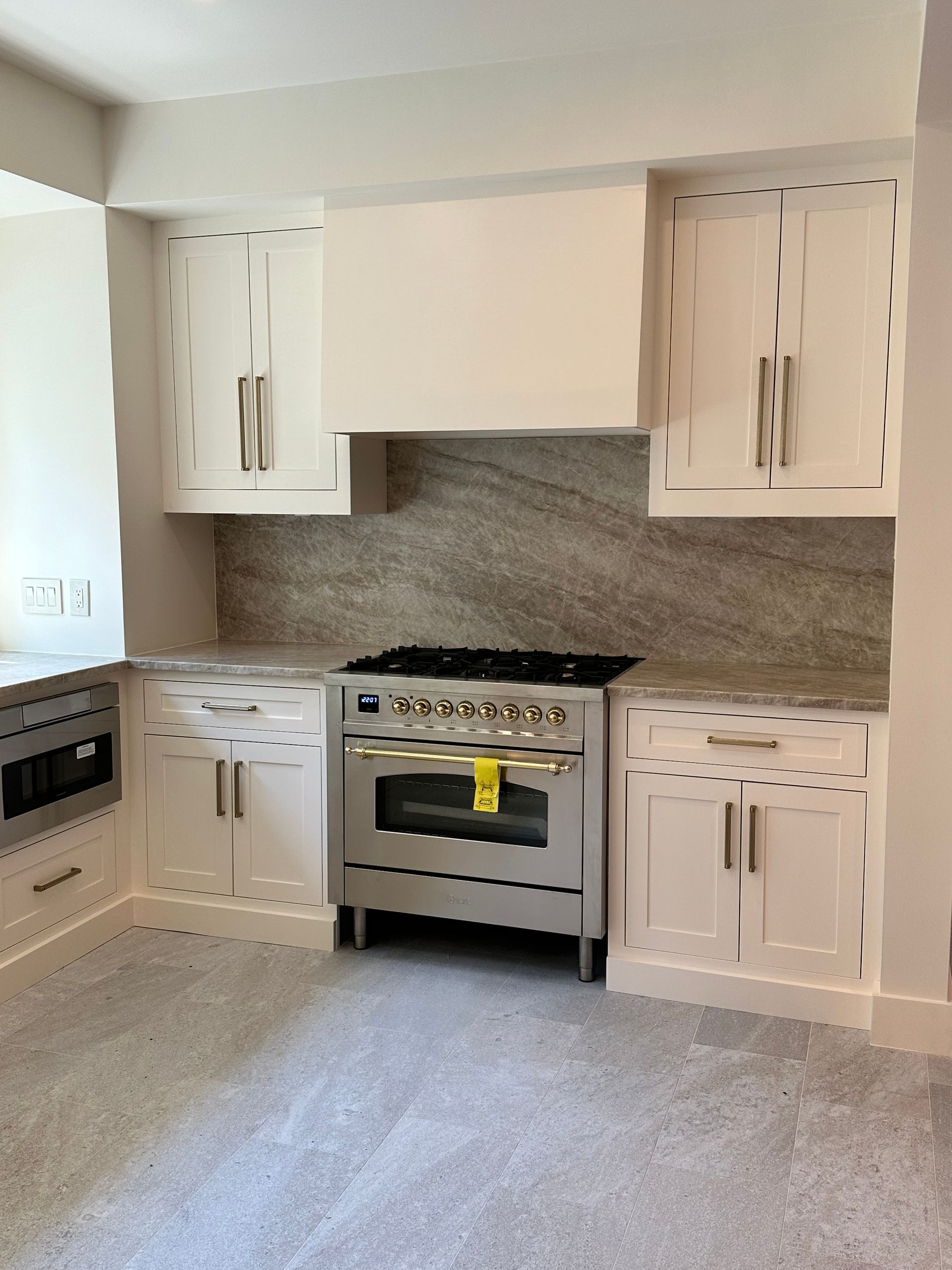 A kitchen with stainless steel appliances and white cabinets