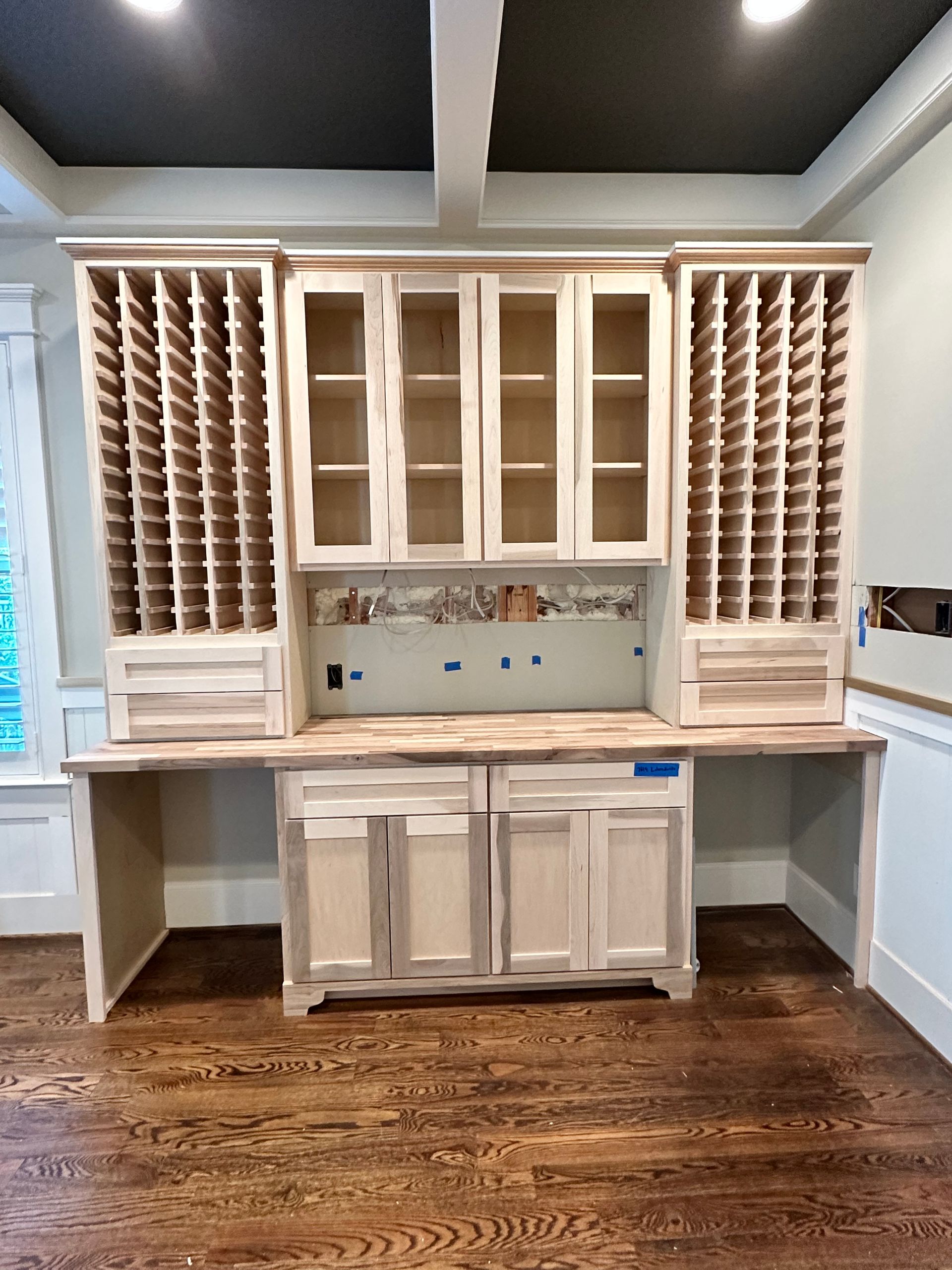 A kitchen with a lot of cabinets and a wooden floor