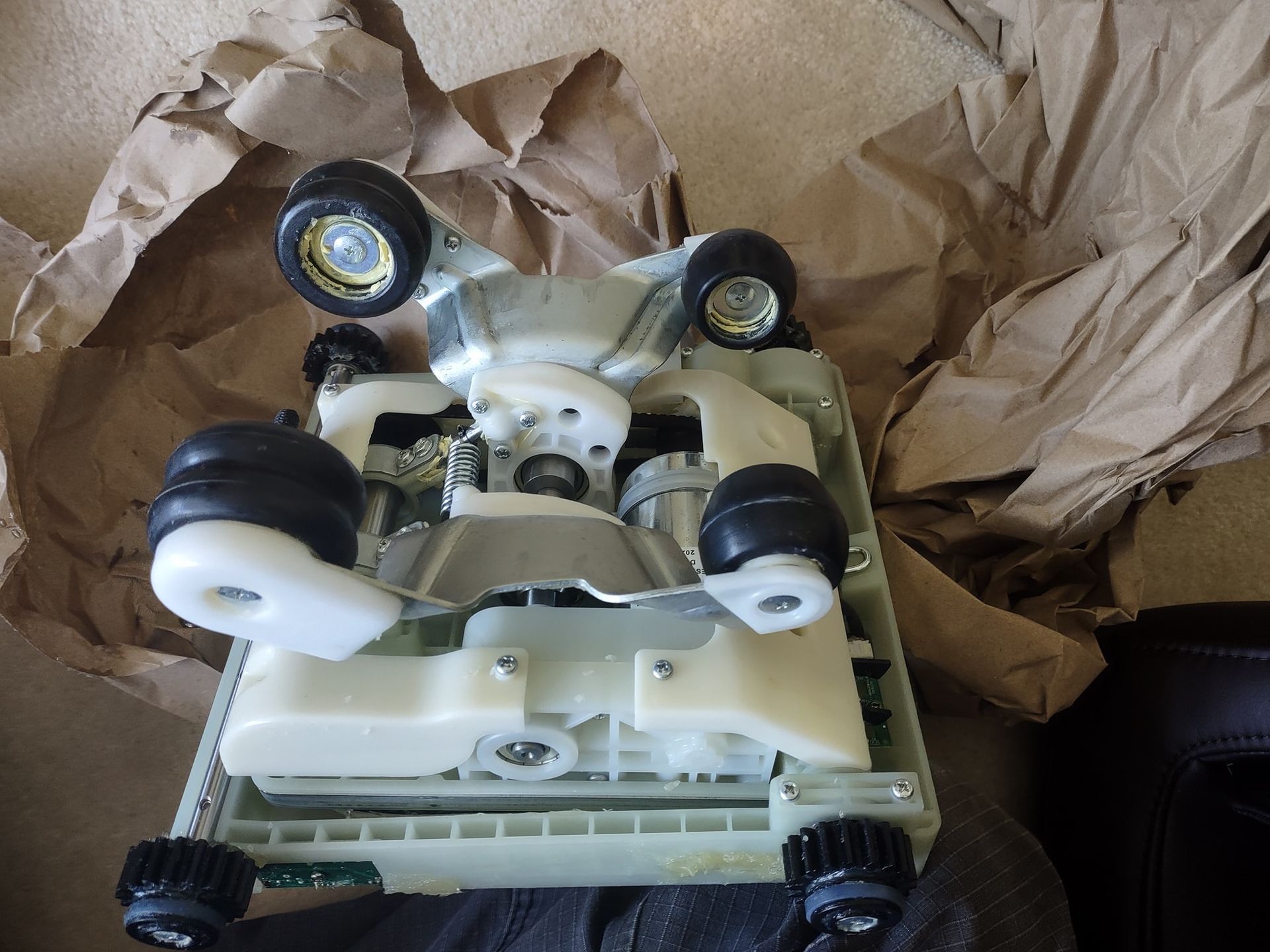 A toy car is sitting on top of a pile of brown paper