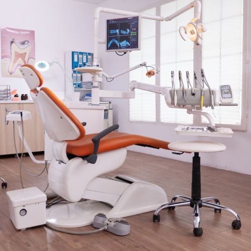 An orange and white dental chair in a dental office