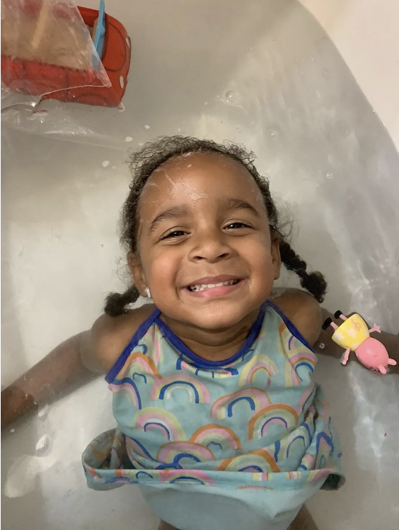 child taking a bath in clear clean water filtered by a water softener.