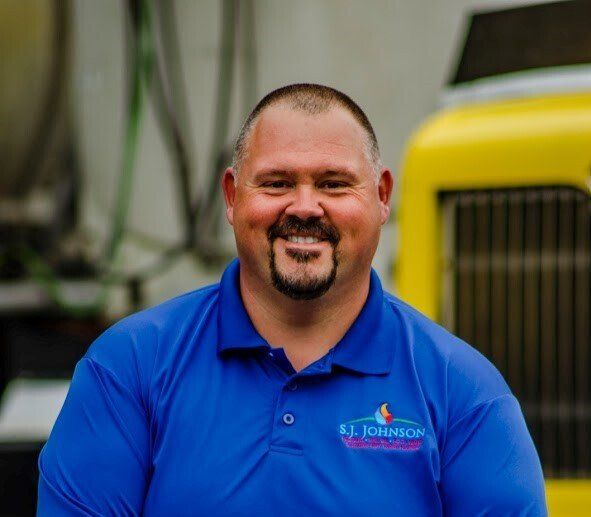 A man wearing a blue shirt with the word johnson on it