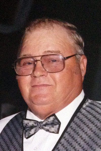 A man wearing glasses and a bow tie