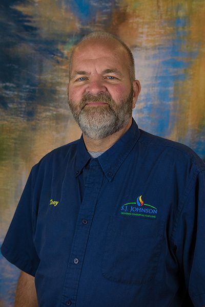 A man with a beard is wearing a blue shirt.