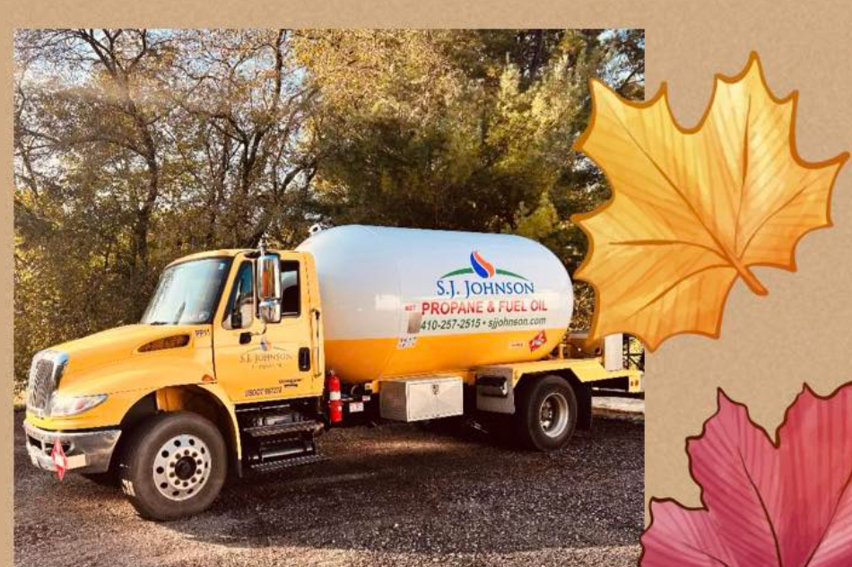 A s.s. johnson propane truck is parked next to a maple leaf