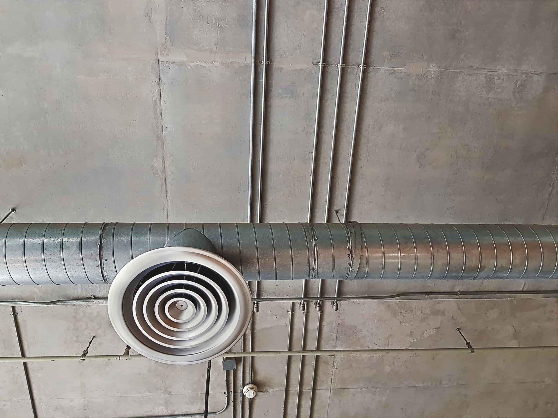 a close up of a ventilation pipe hanging from the ceiling of a building .