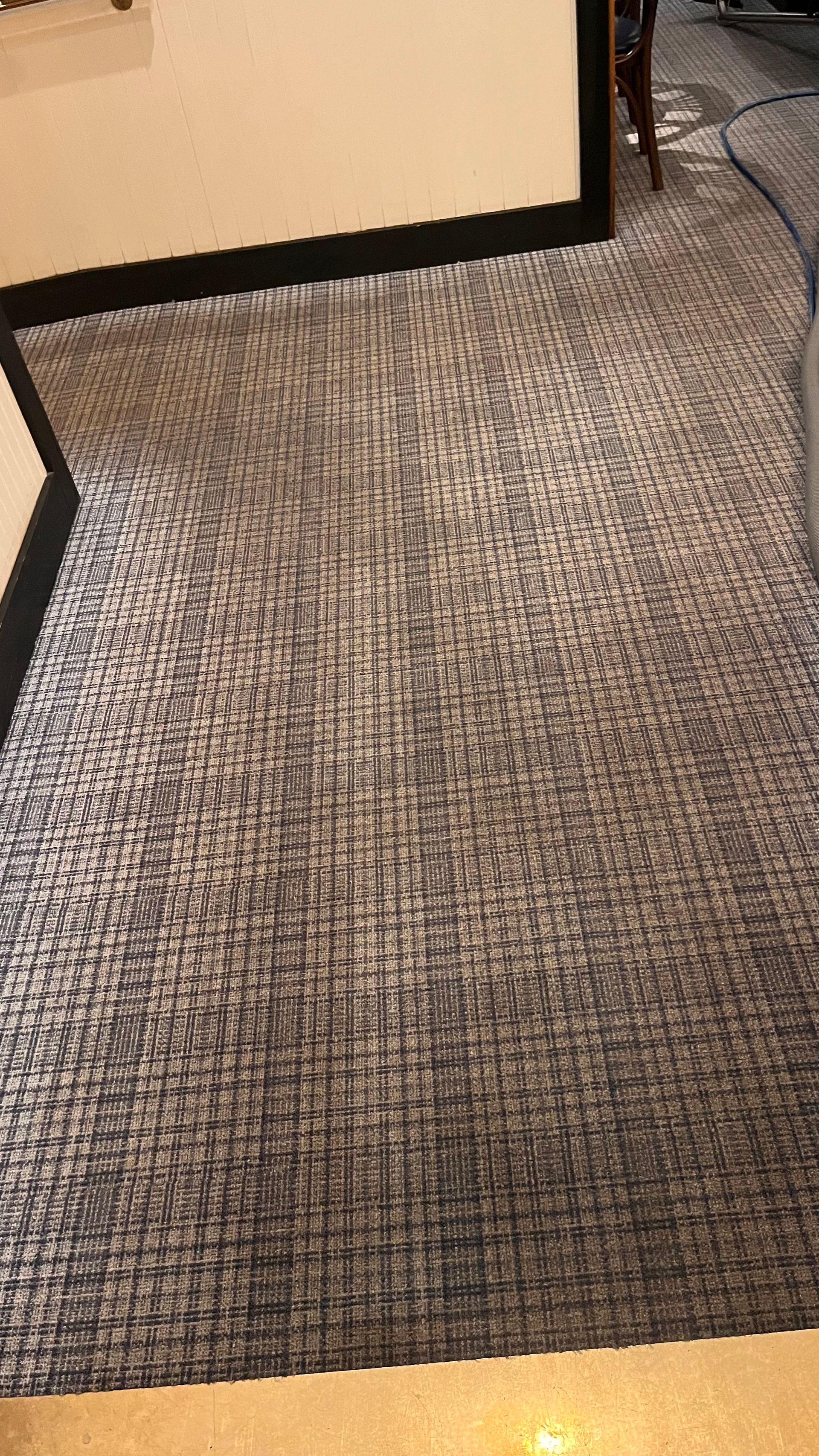 A close up of a rug on a floor in a room.