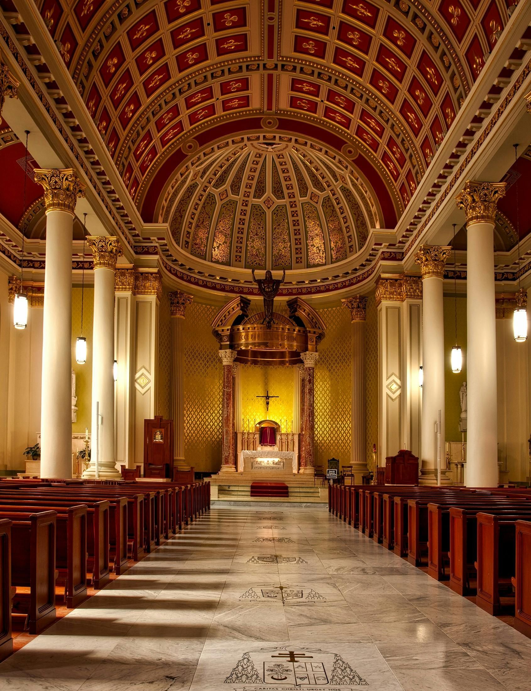 The inside of a church with a dome and columns