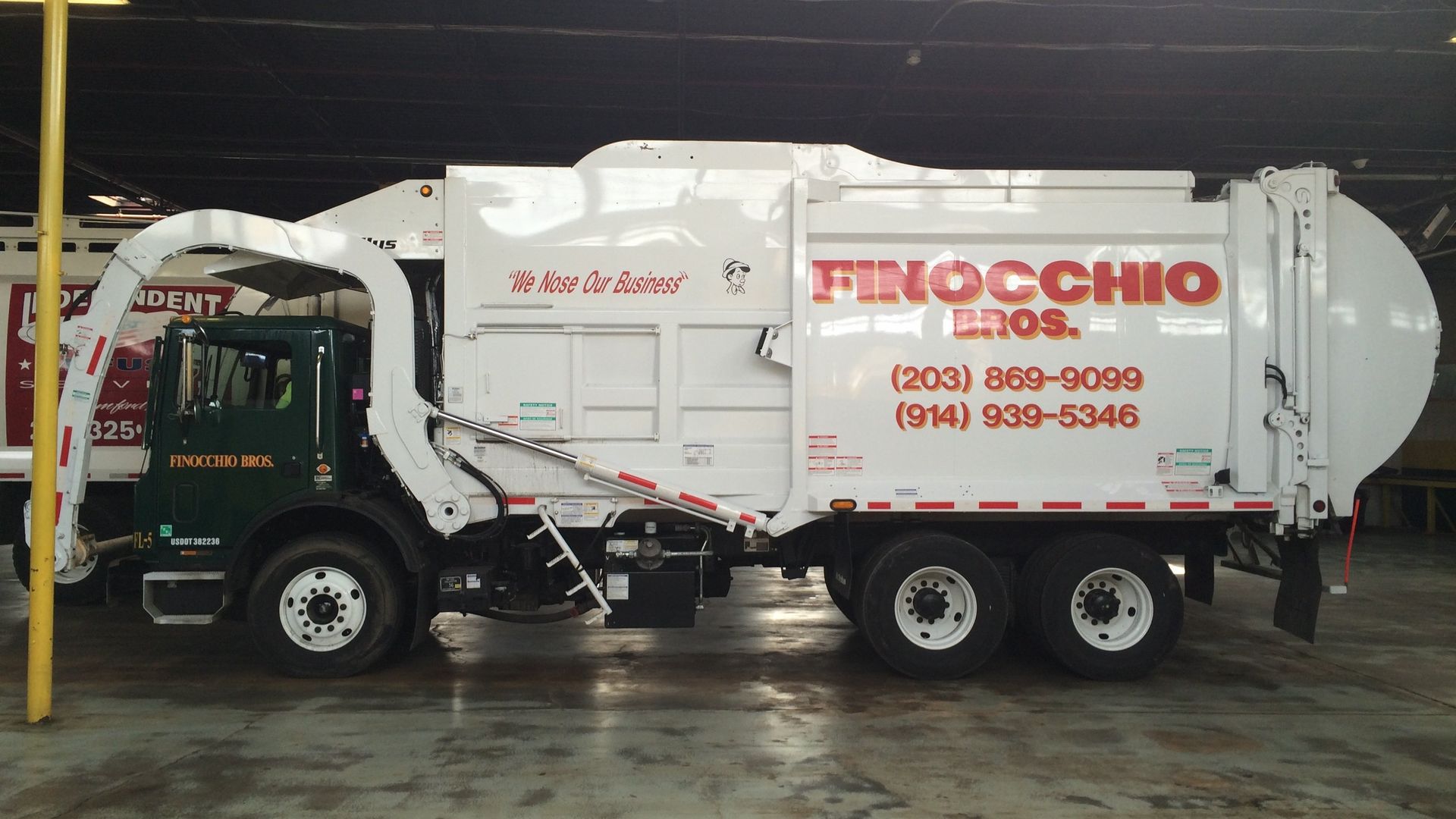White and Dark Green Garbage Truck | Waste Removal Services | Wilton, CT