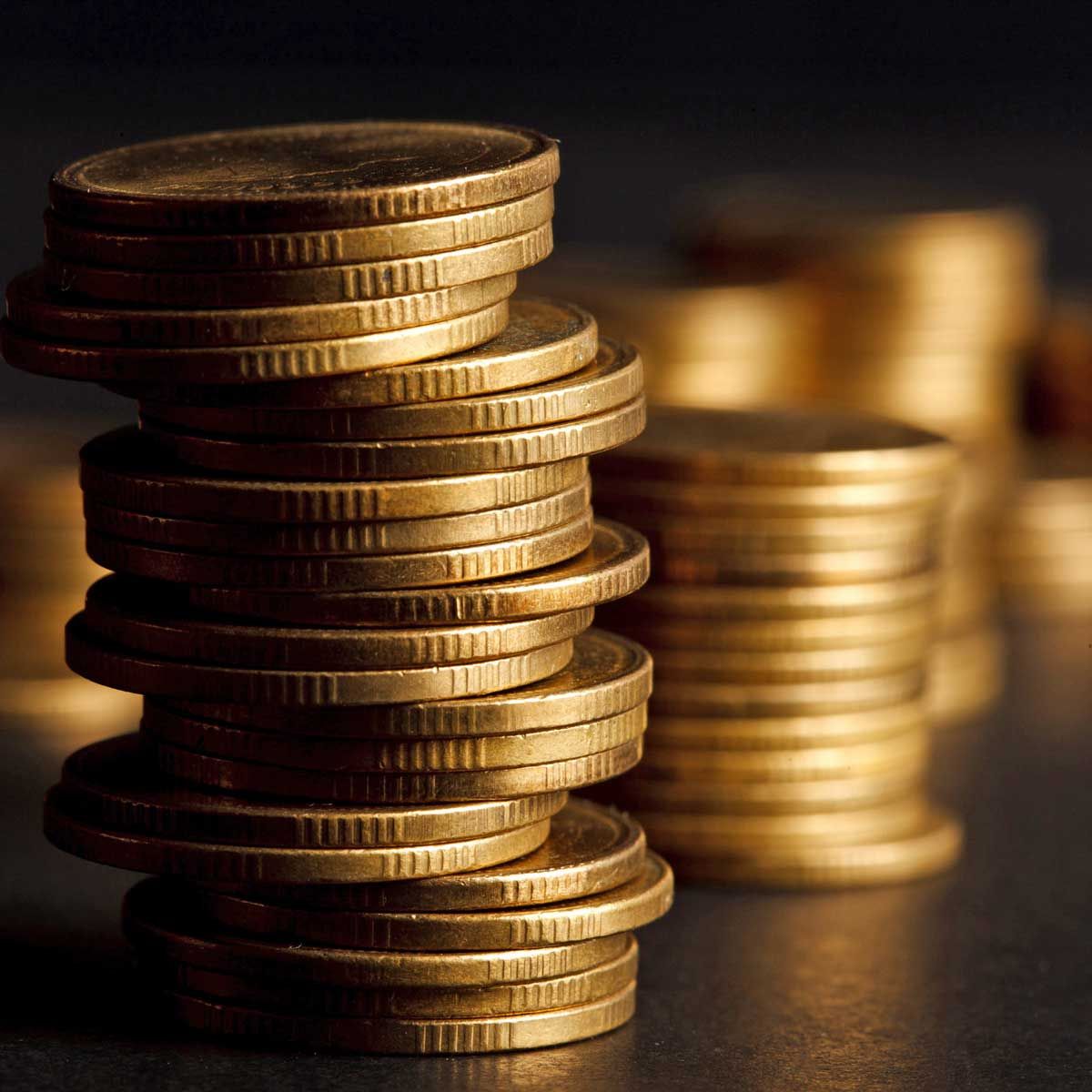 Stacks of gold coins are stacked on top of each other
