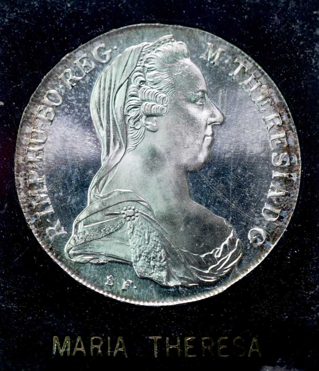 A silver coin of Maria Theresa with a women facing the right side.