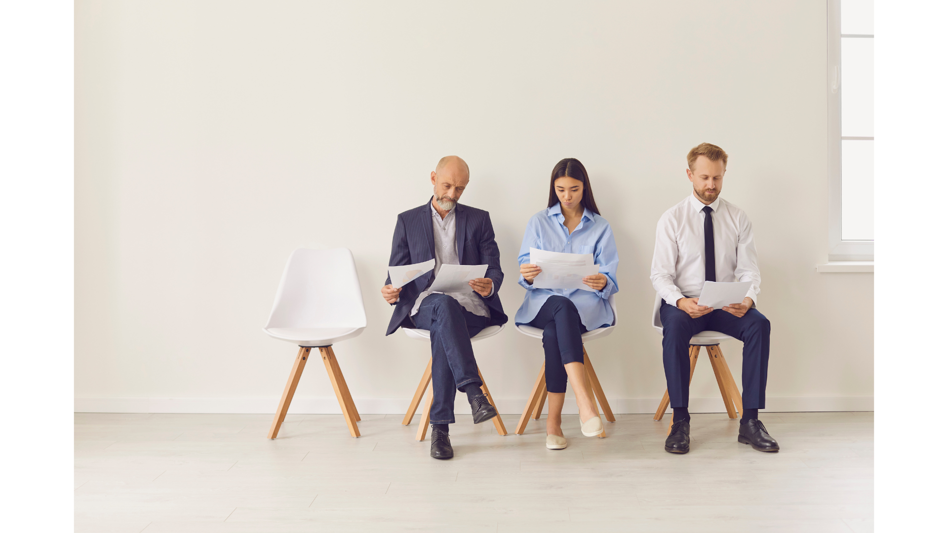 Three people are seated waiting in a room, awaiting an HR representative for fractional employment.