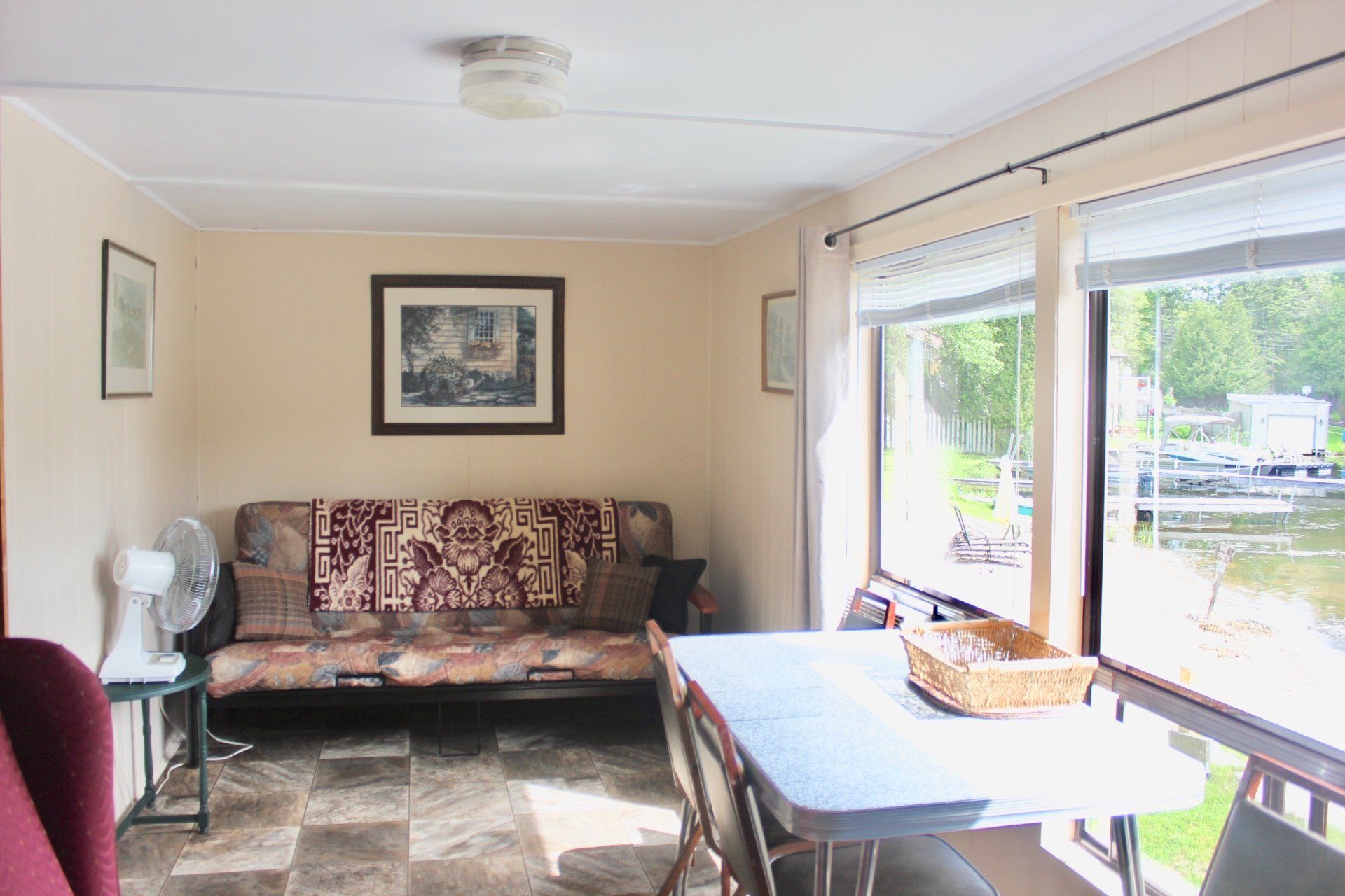 A living room with a couch , table and chairs.