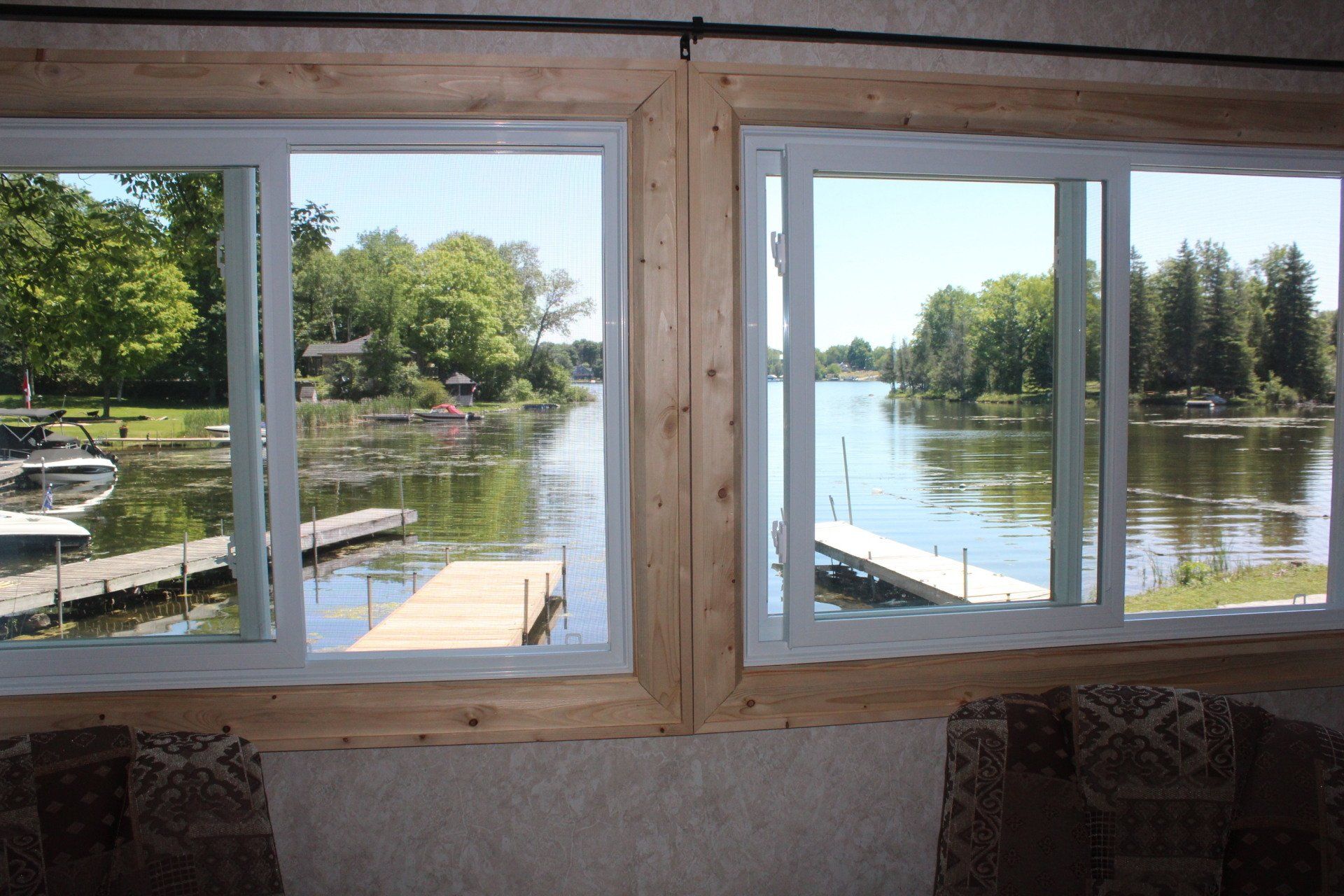 A window with a view of a lake and a dock