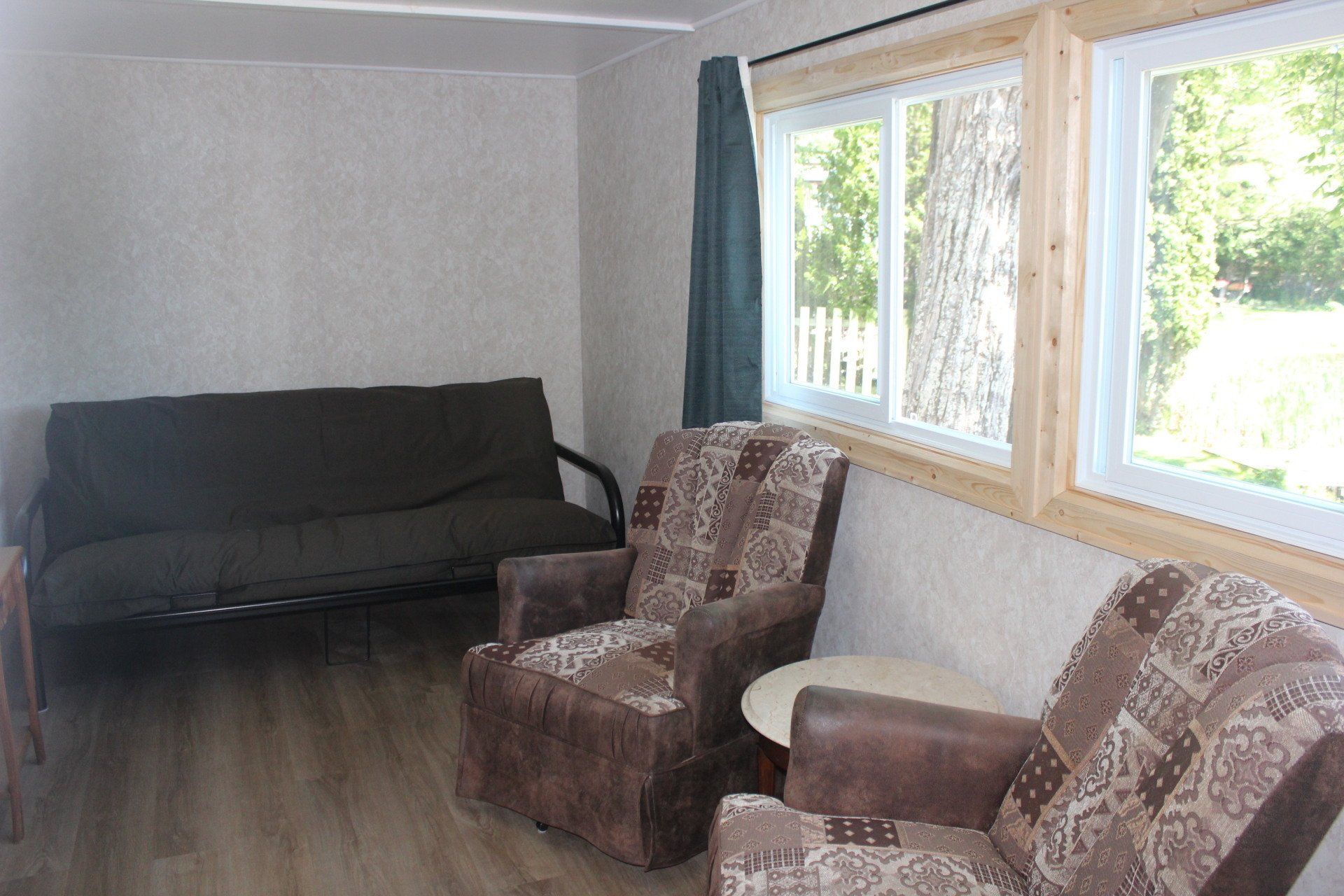 A living room with a couch and two chairs