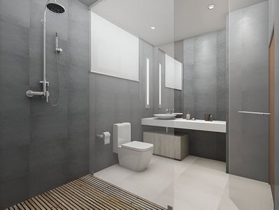 Modern gray bathroom with a walk-in shower, white toilet, and floating vanity with a light wooden cabinet.