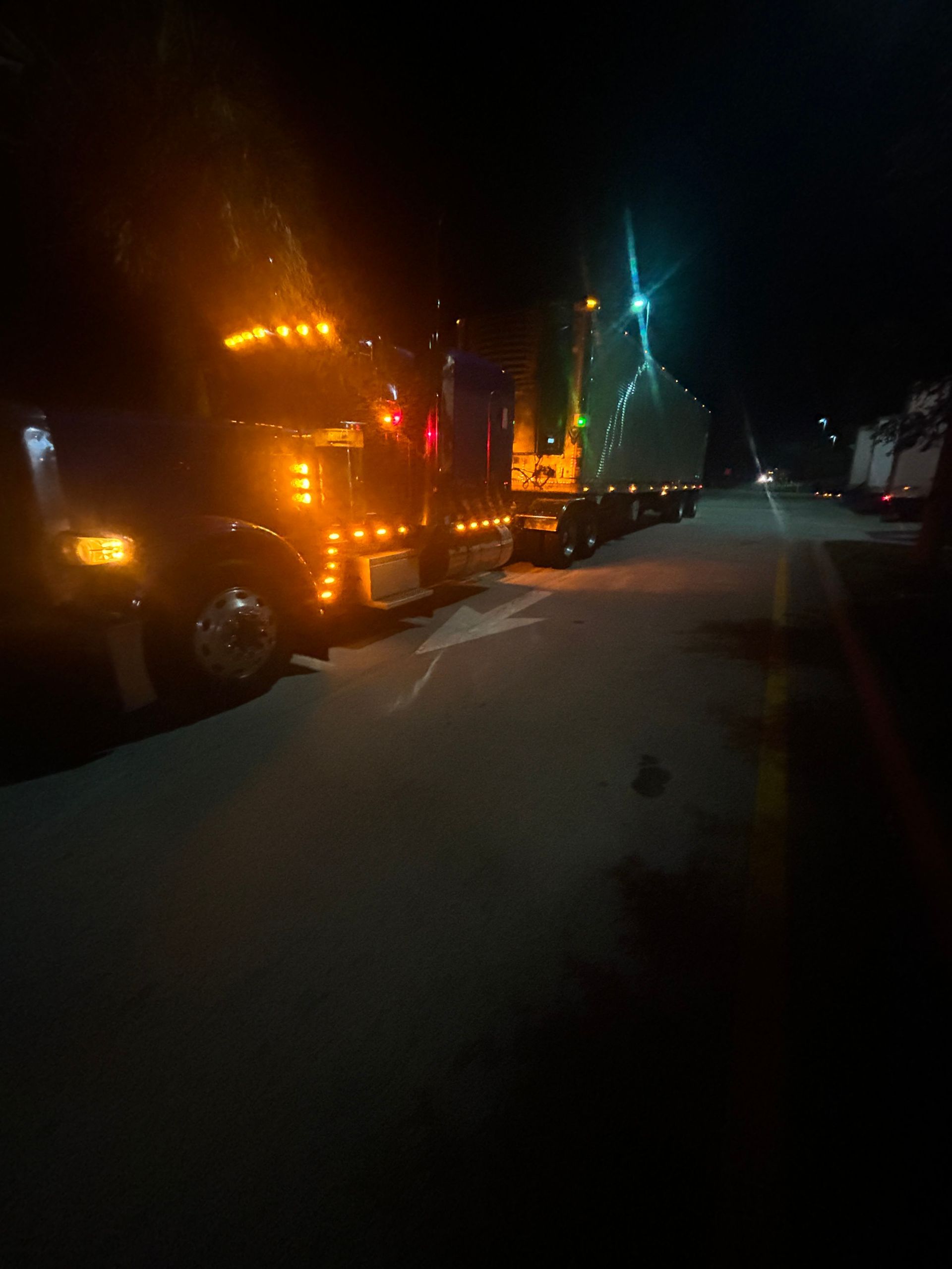 A large red truck is lit up with coca cola lights