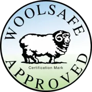 WoolSafe Approved circular certification mark with a black sheep illustration on a blue and green gradient background.